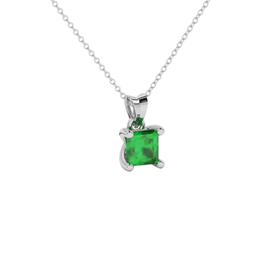 Close-up emerald green gemstone pendant, white gold four-prong setting.