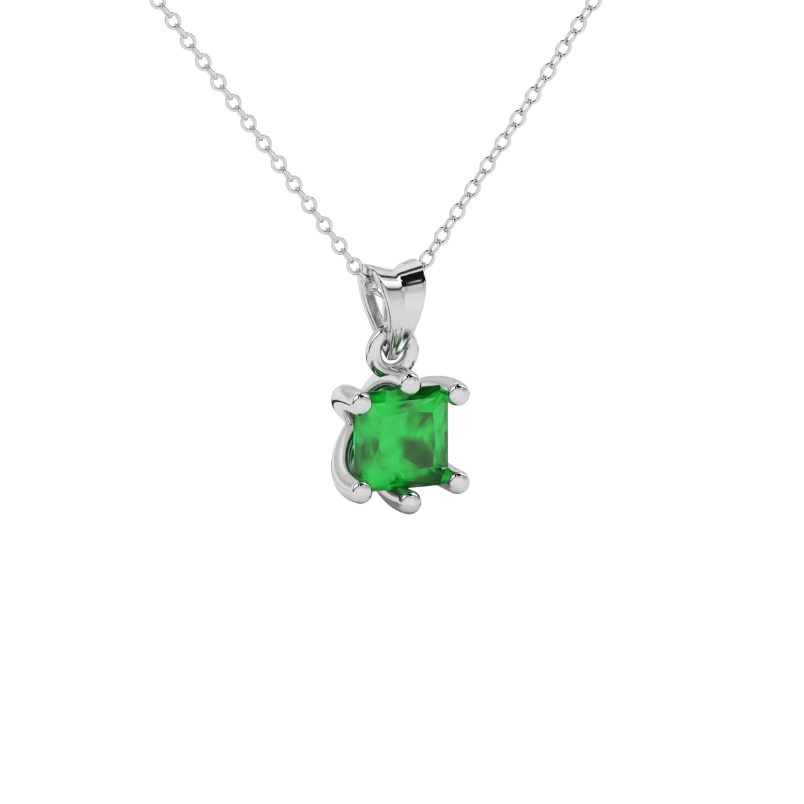 Close-up emerald green gemstone pendant, white gold six-prong setting.