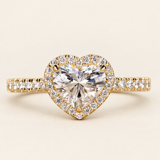 Heart cut lab grown diamond halo engagement ring in yellow gold with protective point prong and pavé diamond shoulders