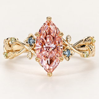 Fancy pink marquise cut lab grown diamond engagement ring with leaf-shaped gold prongs, floral vine shoulders and blue sapphire and peridot accents.