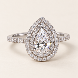 Pear cut lab grown diamond double halo engagement ring in white gold with three center prongs, pavé halos and diamond shoulders