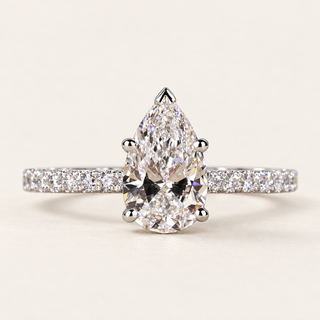 Pear cut lab grown diamond pavé engagement ring in white gold with V-prong pear center and continuous diamond shoulders