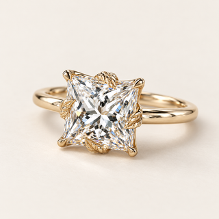 Princess cut lab grown diamond engagement ring with 2.00 ct square center, sculpted leaf-shaped gold prongs, floral basket and plain polished yellow gold shank.