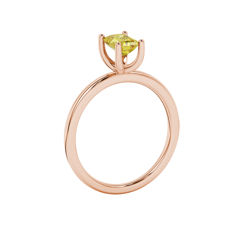 Emerald cut yellow gemstone solitaire ring in gold four prong setting