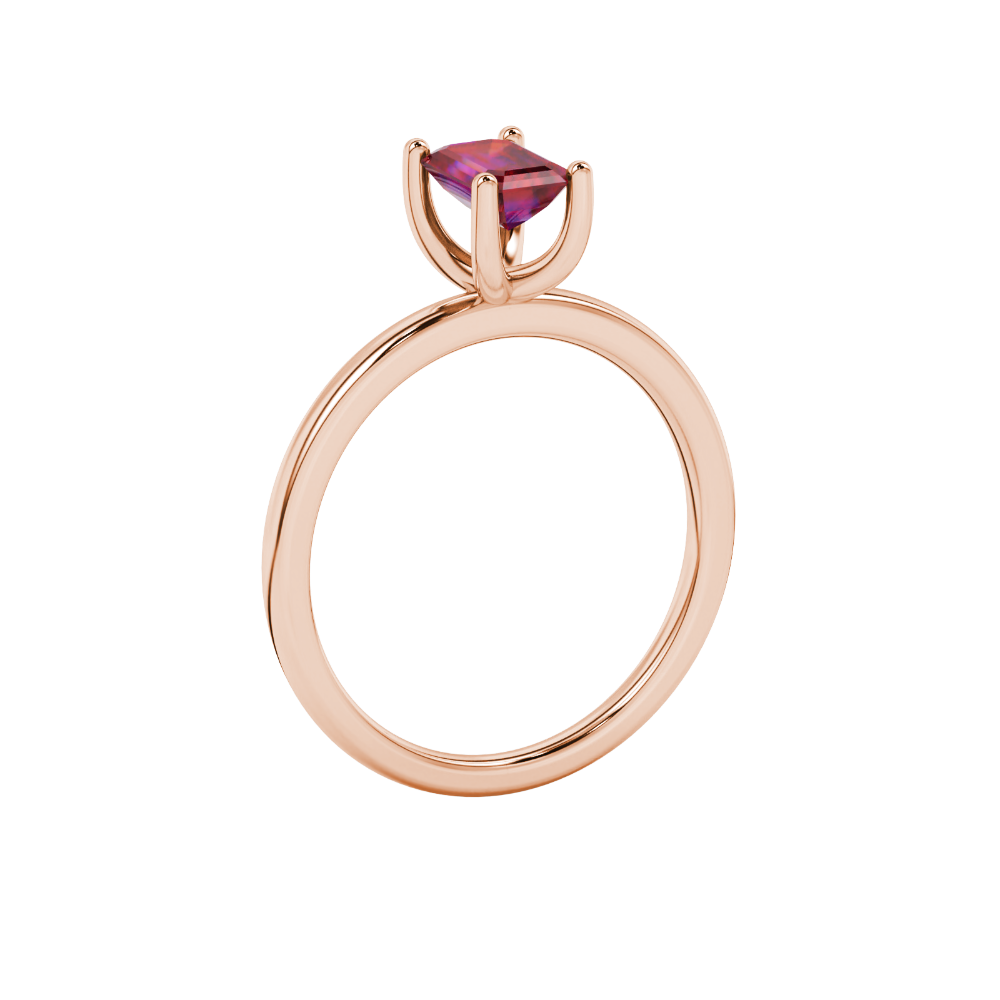 Emerald cut red gemstone solitaire ring in gold four prong setting