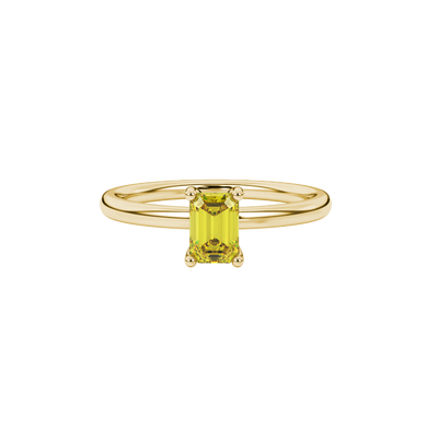 Emerald cut yellow gemstone solitaire ring in gold four prong setting