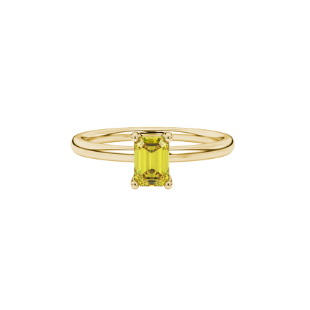 Emerald cut yellow gemstone solitaire ring in gold four prong setting