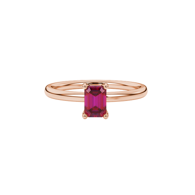Emerald cut red gemstone solitaire ring in gold four prong setting
