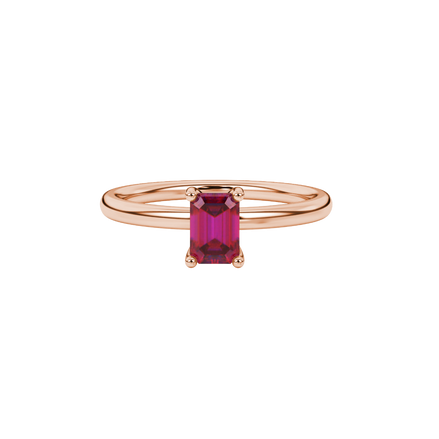 Emerald cut red gemstone solitaire ring in gold four prong setting