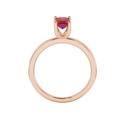 Emerald cut red gemstone solitaire ring in gold four prong setting