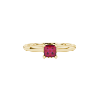 Close-up, princess raspberry red gemstone, yellow gold lotus ring.
