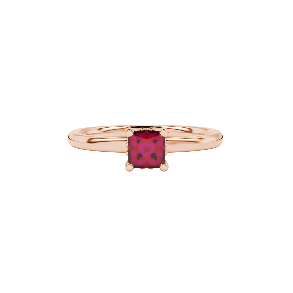 Close-up, princess raspberry red gemstone ring, rose gold lotus setting.