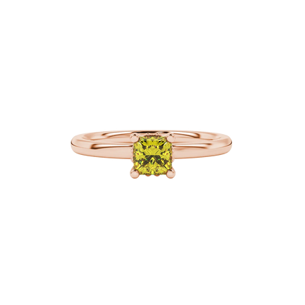 Close-up, princess canary yellow gemstone ring, rose gold lotus setting.