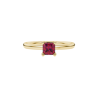 Close-up, princess raspberry red gemstone, yellow gold surprise ring.