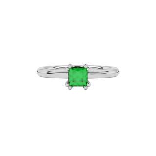 Close-up emerald green gemstone ring, white gold vintage setting.