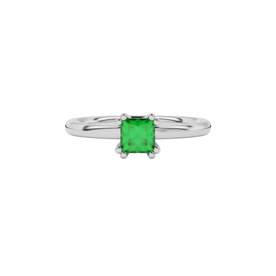 Close-up emerald green gemstone ring, white gold vintage setting.