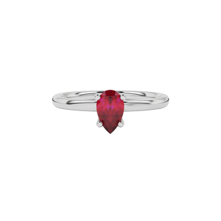 Close-up raspberry red gemstone ring, white gold four-prong setting.