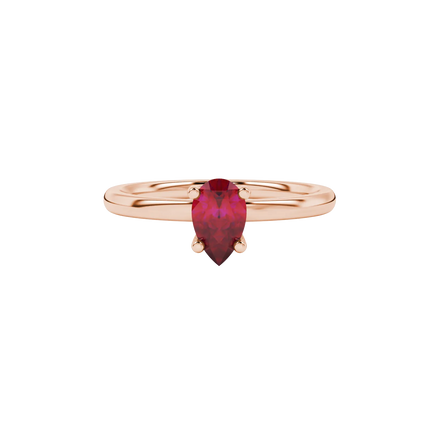 Close-up, pear shape raspberry red gemstone ring, rose gold four-prong setting.