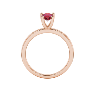 Pear shape raspberry red gemstone ring, rose gold four-prong setting.