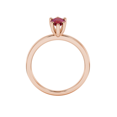 Pear shape raspberry red gemstone ring, rose gold six-prong setting.