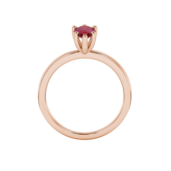 Pear shape raspberry red gemstone ring, rose gold six-prong setting.