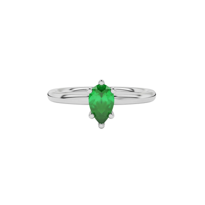 Close-up emerald green gemstone ring, white gold six-prong setting.