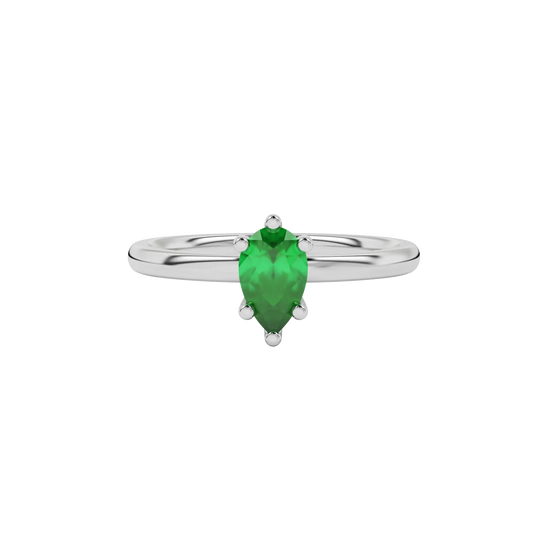Close-up emerald green gemstone ring, white gold six-prong setting.