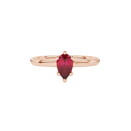 Close-up, pear shape raspberry red gemstone ring, rose gold six-prong setting.