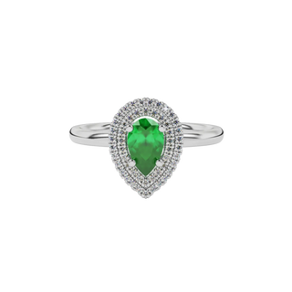 Close-up emerald green gemstone ring, white gold halo setting.