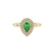 Close-up, pear shape emerald green gemstone, yellow gold halo ring.