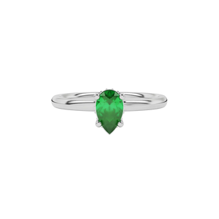 Close-up emerald green gemstone ring, white gold pavé basket.