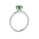 Side profile, white gold emerald green ring, scalloped six-prong gallery.