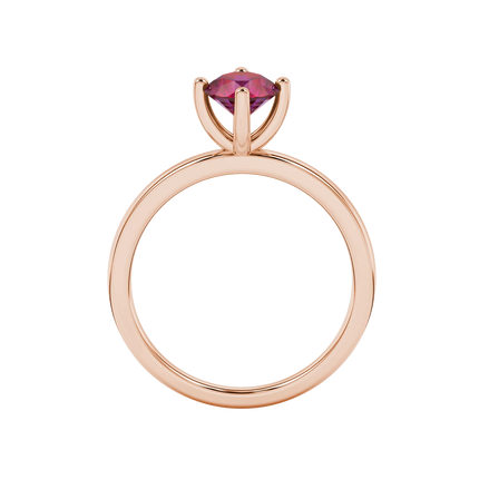 Round-cut raspberry red gemstone solitaire ring in a rose gold four-prong setting.