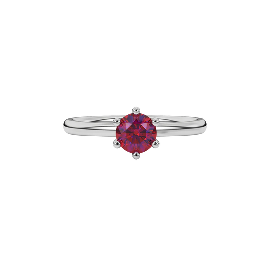 Close-up details of a round raspberry red gemstone secured in a white gold six-prong setting.