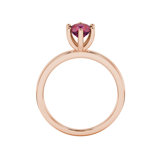 Round-cut raspberry red gemstone solitaire ring in a rose gold six-prong setting.