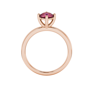 Round-cut raspberry red gemstone solitaire ring in a rose gold classic basket setting.