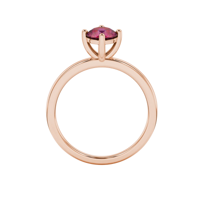 Round-cut raspberry red gemstone solitaire ring in a rose gold classic basket setting.