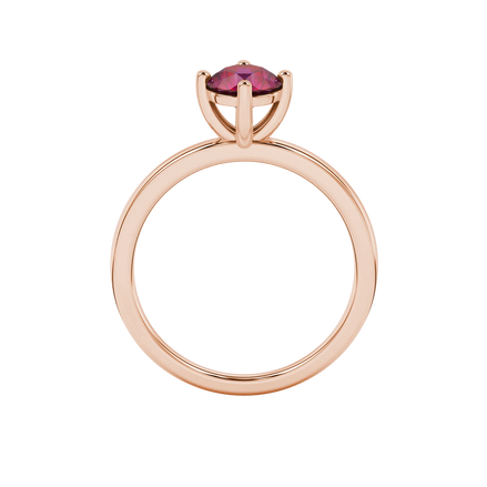 Round-cut raspberry red gemstone solitaire ring in a rose gold classic basket setting.