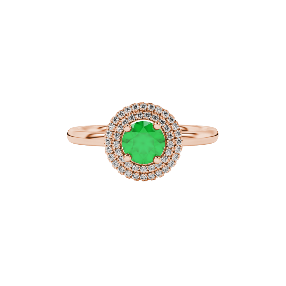 Close-up macro shot of a round emerald green gemstone ring with a rose gold diamond falling edge halo.