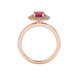 Round-cut raspberry red gemstone solitaire ring in a rose gold falling edge halo diamond setting.