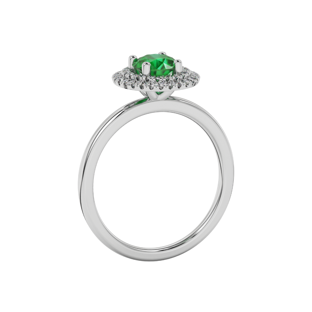 Side view of a white gold emerald green gemstone ring featuring a brilliant falling edge halo.