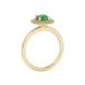 Side profile of a yellow gold emerald green gemstone ring with a falling edge halo design
