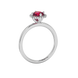 Side angle of a white gold raspberry red gemstone ring highlighting the French pavé halo details.