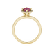 Round-cut raspberry red gemstone solitaire ring in a yellow gold French pavé halo diamond setting.