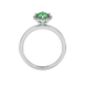 Round-cut emerald green gemstone solitaire ring in a white gold French pavé halo diamond setting.