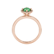 Round-cut emerald green gemstone solitaire ring in a rose gold French pavé halo diamond setting.