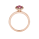 Round-cut raspberry red gemstone solitaire ring in a rose gold French pavé halo diamond setting.