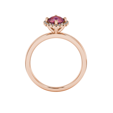 Round-cut raspberry red gemstone solitaire ring in a rose gold French pavé halo diamond setting.