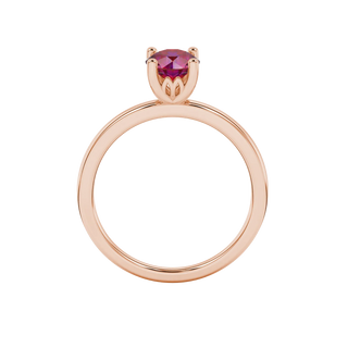 Round-cut raspberry red gemstone solitaire ring in a rose gold lotus basket setting