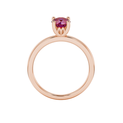 Round-cut raspberry red gemstone solitaire ring in a rose gold lotus basket setting